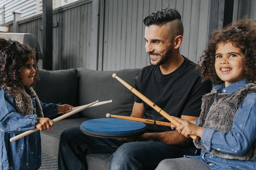 kids drumming on a practice pad